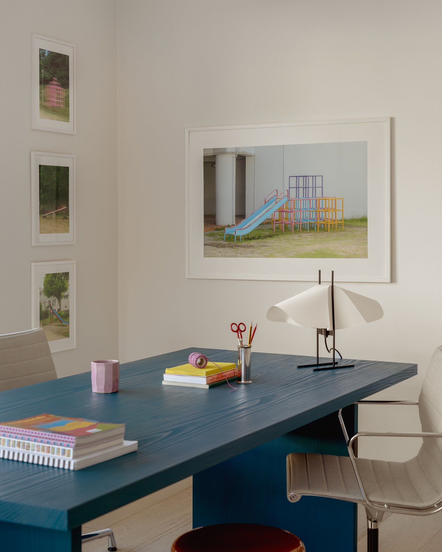 Prints by Jennilee Marigomen above desk and lamp.